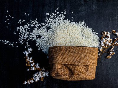 rice in sack,white rice in burlap sack with rice grain on the black wood