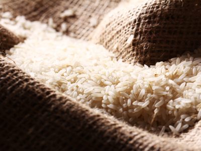 Close up of white rice grains on the sack cloth